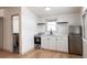 Small, updated kitchen with white cabinets and modern appliances at 860 S Quivas St, Denver, CO 80223