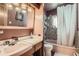 Bathroom featuring a pink sink and tub, tiled walls, and a shower at 10150 W 25Th Ave, Lakewood, CO 80215