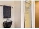 Bathroom featuring a sleek black toilet, chrome towel rack, and glass shower door at 10150 W 25Th Ave, Lakewood, CO 80215