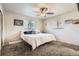Cozy bedroom with a comfortable bed, ceiling fan, and natural light from two windows at 10150 W 25Th Ave, Lakewood, CO 80215