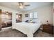 Bedroom with carpet flooring, ceiling fan, and a window overlooking the backyard at 10150 W 25Th Ave, Lakewood, CO 80215