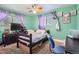 Bedroom with a single bed, windows with curtains, and a ceiling fan at 10150 W 25Th Ave, Lakewood, CO 80215