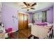 Bedroom features wooden floors, built-in closet, and ceiling fan at 10150 W 25Th Ave, Lakewood, CO 80215