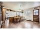 Cozy dining room featuring tile floors and a wooden table with seating for four, perfect for Gathering meals at 10150 W 25Th Ave, Lakewood, CO 80215