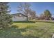 Home with brick and lawn, large tree in the front yard at 10150 W 25Th Ave, Lakewood, CO 80215