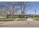 Charming home featuring a welcoming front porch and well-manicured lawn, shaded by mature trees at 10150 W 25Th Ave, Lakewood, CO 80215
