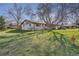 Charming single-story home featuring mature trees, a spacious lawn, and inviting curb appeal at 10150 W 25Th Ave, Lakewood, CO 80215