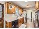 Traditional kitchen featuring wood cabinets, tiled floor, and bright sink window at 10150 W 25Th Ave, Lakewood, CO 80215