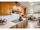 Kitchen featuring wooden cabinets, a built-in cooktop, and an adjacent dining area at 10150 W 25Th Ave, Lakewood, CO 80215