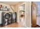 Laundry room featuring a modern washer and dryer and an open doorway to the kitchen at 10150 W 25Th Ave, Lakewood, CO 80215