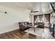 Bright living room showcasing hardwood floors, comfortable seating, and a cozy fireplace at 10150 W 25Th Ave, Lakewood, CO 80215