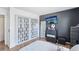 Neat bedroom features unique closet doors, a flatscreen TV, and wood flooring at 1272 S Uvalda St, Aurora, CO 80012