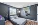 Modern bedroom with dark accent wall, sleek furniture, and stylish decor at 1272 S Uvalda St, Aurora, CO 80012