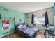 Colorful bedroom featuring hardwood floors, artwork, and ample natural light at 1272 S Uvalda St, Aurora, CO 80012
