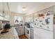 Well-lit kitchen with stainless steel appliances, granite countertops, and ample cabinet space at 1272 S Uvalda St, Aurora, CO 80012