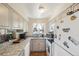 Well-lit kitchen with stainless steel appliances, granite countertops, and ample cabinet space at 1272 S Uvalda St, Aurora, CO 80012