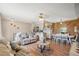 Open-concept living area featuring a wood accent wall, wood flooring, and a comfortable seating arrangement at 1272 S Uvalda St, Aurora, CO 80012