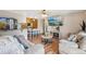 Inviting living room with views into kitchen and dining, plus comfortable seating and wood flooring at 1272 S Uvalda St, Aurora, CO 80012