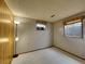 Basement with carpet flooring, wood paneling, and natural light from the two windows at 2663 S Laredo St, Aurora, CO 80013