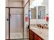 Bathroom features a step-in shower with tile surround, granite countertop, and updated fixtures at 4322 N Meadows Dr, Castle Rock, CO 80109
