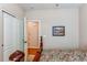 View of bedroom featuring closet, doorway to another room, hardwood floors and an artwork piece at 4322 N Meadows Dr, Castle Rock, CO 80109