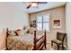 Cozy bedroom features a ceiling fan, a window with white shutters and a well decorated bed at 4322 N Meadows Dr, Castle Rock, CO 80109