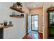 Inviting foyer featuring hardwood floors and decorative floating shelves at 4322 N Meadows Dr, Castle Rock, CO 80109