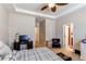 Comfortable main bedroom featuring a ceiling fan, adjacent bath, and decorative desk and drawers at 4322 N Meadows Dr, Castle Rock, CO 80109