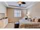 The main bedroom includes a tray ceiling, a plush bed, a dresser, and a window with white shutters at 4322 N Meadows Dr, Castle Rock, CO 80109