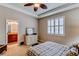 Spacious main bedroom featuring tray ceilings, plush bed, a white dresser and window with shutters at 4322 N Meadows Dr, Castle Rock, CO 80109