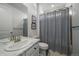 Cozy bathroom with marble countertops, elegant fixtures, and a decorative shower curtain adding a touch of sophistication at 8390 S Cody Way, Littleton, CO 80128