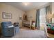 Comfortable Bedroom with a cozy armchair, soft carpet, and a well-appointed crib ready for a new arrival at 8390 S Cody Way, Littleton, CO 80128