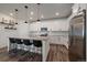 Modern kitchen with stainless steel appliances, granite countertops, an island and white cabinets at 8390 S Cody Way, Littleton, CO 80128
