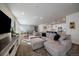 Spacious living area boasts natural light, stylish furniture, and seamless flow into the dining space at 8390 S Cody Way, Littleton, CO 80128