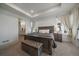 Inviting main bedroom with a tray ceiling, large windows, a comfortable bed, and stylish furnishings at 8390 S Cody Way, Littleton, CO 80128