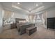 Spacious main bedroom with tray ceiling, plush carpet, and ample natural light from many windows at 8390 S Cody Way, Littleton, CO 80128