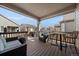 Covered porch featuring comfortable seating and an inviting table setup, perfect for outdoor relaxation and gatherings at 8390 S Cody Way, Littleton, CO 80128