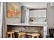 Basement bar featuring a rustic wood facade, bright white counter, and ample seating at 787 Huntington Pl, Highlands Ranch, CO 80126