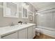 Bright bathroom featuring a double sink vanity, framed mirrors, and a shower-tub combo at 787 Huntington Pl, Highlands Ranch, CO 80126