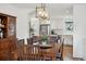 Dining area with a wooden table and chairs next to the open-concept kitchen with stainless steel appliances at 787 Huntington Pl, Highlands Ranch, CO 80126
