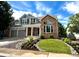 Charming home with brick and siding exterior, featuring a well-maintained lawn and attractive rock landscaping at 787 Huntington Pl, Highlands Ranch, CO 80126