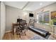 This home gym features a desk area and a treadmill for all your home workout needs at 787 Huntington Pl, Highlands Ranch, CO 80126
