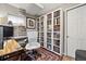 This home office features custom built-in bookshelves, desk and chair set with a large window at 787 Huntington Pl, Highlands Ranch, CO 80126