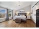 Serene main bedroom featuring hardwood floors, natural light, stylish furniture, and a walk-in closet at 787 Huntington Pl, Highlands Ranch, CO 80126