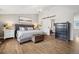 Bright main bedroom with hardwood floors, a comfortable bed, and elegant decor, creating a relaxing atmosphere at 787 Huntington Pl, Highlands Ranch, CO 80126