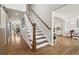 Inviting foyer featuring a wooden staircase with white risers and natural hardwood flooring that leads to the upper level at 787 Huntington Pl, Highlands Ranch, CO 80126