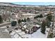 Aerial shot of townhouses with snow-covered roofs, complemented by nearby trees and mountains at 14585 W 32Nd Ave, Golden, CO 80401