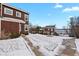 Exterior view of townhouses with manicured lawns and sidewalks, near a serene lake at 14585 W 32Nd Ave, Golden, CO 80401