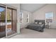 Serene bedroom with ample natural light, plush carpeting, and a sliding glass door to the outside at 14585 W 32Nd Ave, Golden, CO 80401