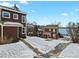 Exterior view of townhouses with manicured lawns and sidewalks, near a serene lake at 14585 W 32Nd Ave, Golden, CO 80401